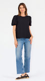 Short haired brunette woman wearing a short sleeve black colored top with cut out detail on puff sleeves