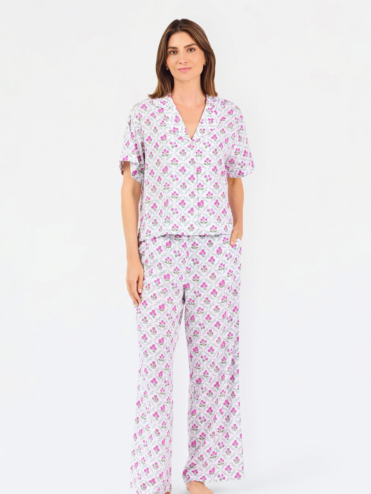 Woman wearing a purple floral pajama set on a white background