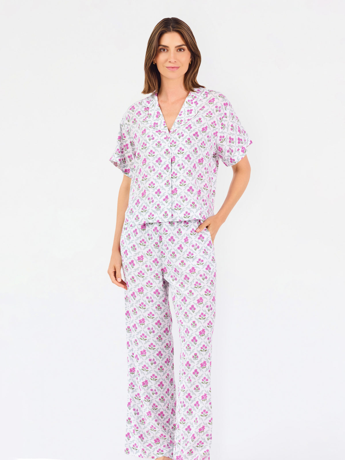 Woman wearing a purple floral pajama set on a white background
