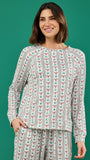 A woman modeling a matching long-sleeve top and pants set with a vertical striped pattern featuring red bows and green leaves on a white background, set against a solid green backdrop.