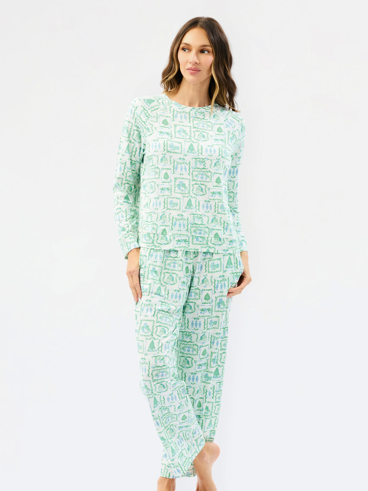 A woman modeling a two-piece long-sleeve pajama set with a light mint green and white geometric pattern, shot against a plain white studio background.