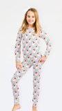 A young girl modeling a long-sleeve pajama set with a white base, vertical blue stripes, and red fox prints, set against a plain white background.