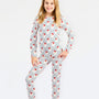A young girl modeling a long-sleeve pajama set with a white base, vertical blue stripes, and red fox prints, set against a plain white background.