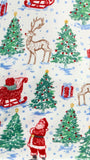 A festive Christmas-themed fabric pattern featuring Santa Claus, reindeer, Christmas trees, sleds, candy canes, and wrapped gifts on a white background with light blue snowflake details.