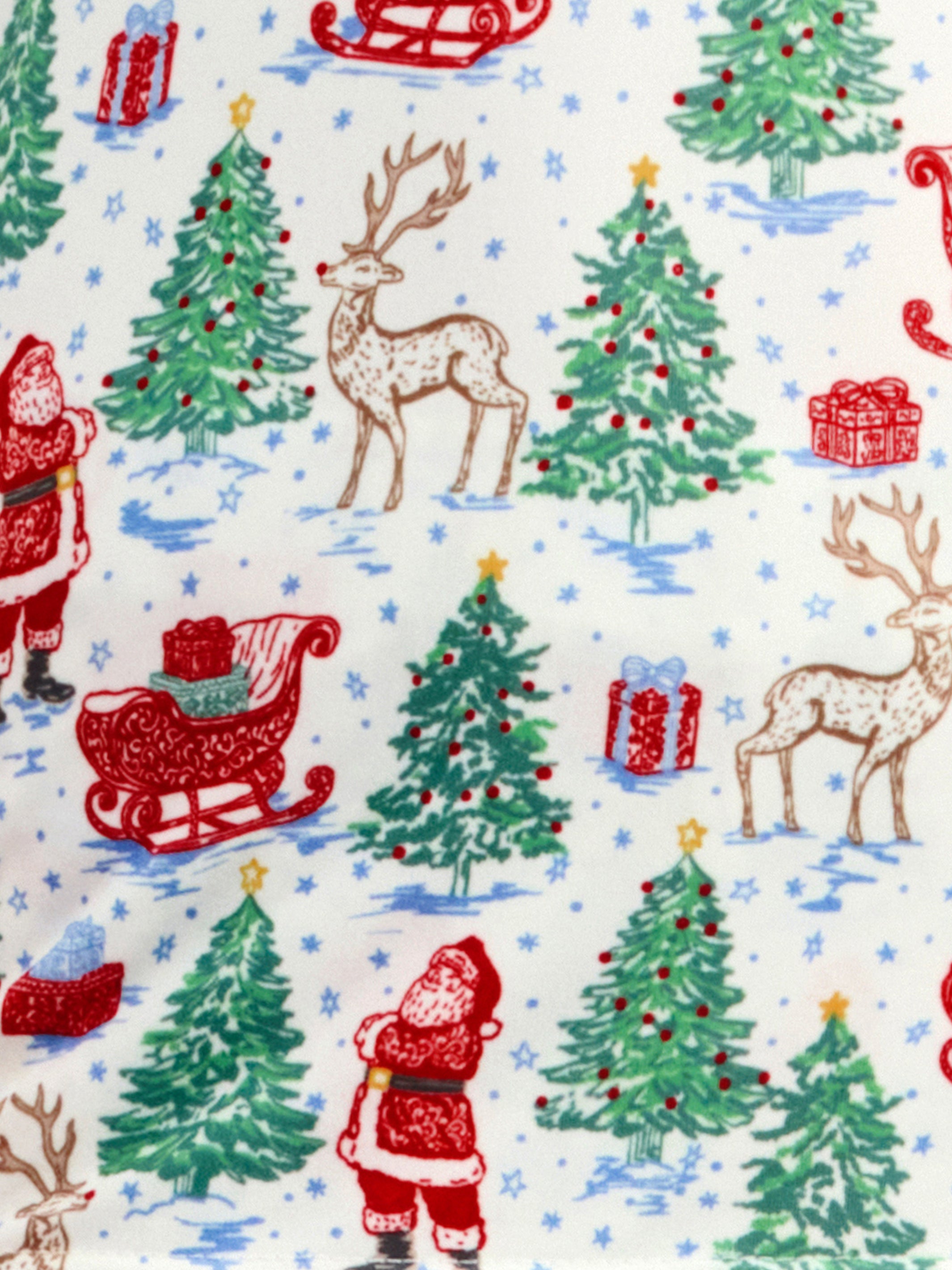 A festive Christmas-themed fabric pattern featuring Santa Claus, reindeer, Christmas trees, sleds, candy canes, and wrapped gifts on a white background with light blue snowflake details.