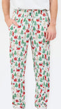 A person wearing holiday-themed lounge pants with an all-over Christmas print featuring Santa Claus, reindeer, trees, and sleighs on a white background.