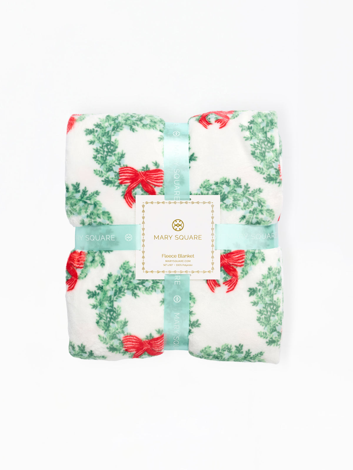 A folded Mary Square floral blanket with a green wreath and red bow pattern, wrapped in a light blue ribbon with a white brand label.