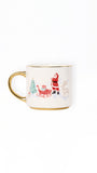 A white ceramic mug with a gold handle and gold rim, decorated with a festive Christmas illustration featuring Santa Claus, a reindeer, a sleigh, and a Christmas tree.
