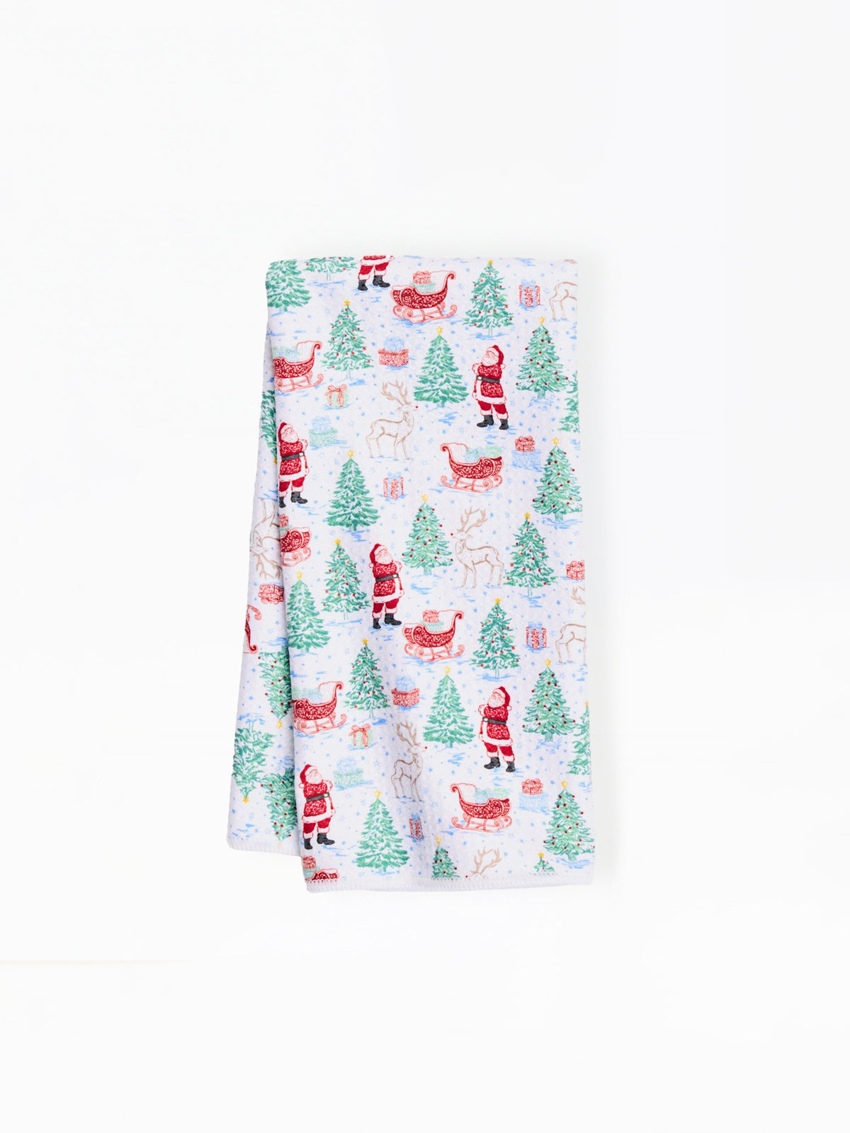 A folded white kitchen towel featuring a festive Christmas print with Santa Claus, reindeer, Christmas trees, and gifts on a clean white background.