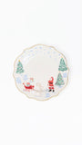 A scalloped ceramic plate with a festive Christmas design, featuring Santa Claus, a reindeer, and snow-covered pine trees on a white background with a thin gold rim.
