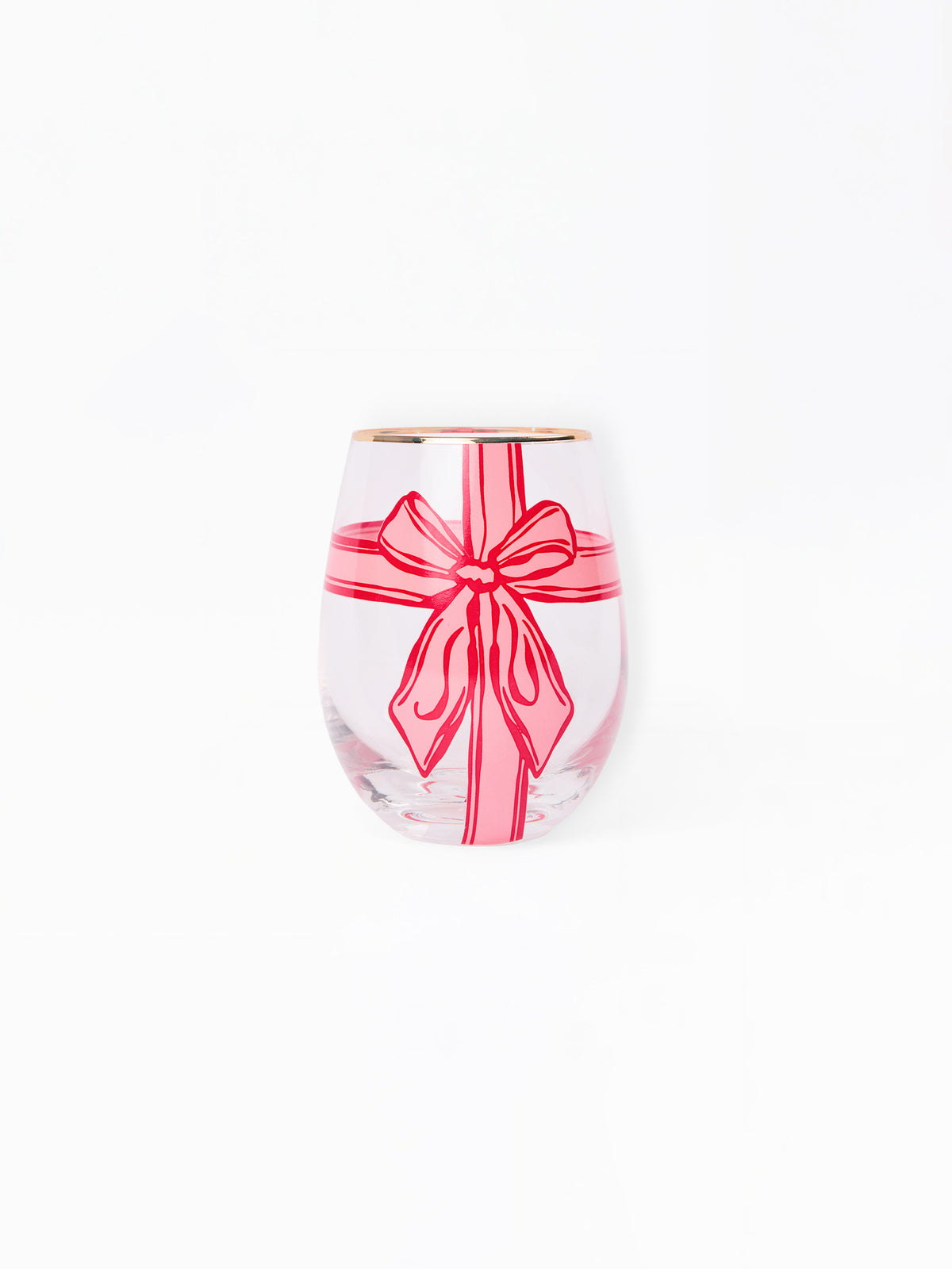 A clear stemless wine glass featuring a pink gift box design with a red ribbon and bow, finished with a gold rim, set against a plain white background.