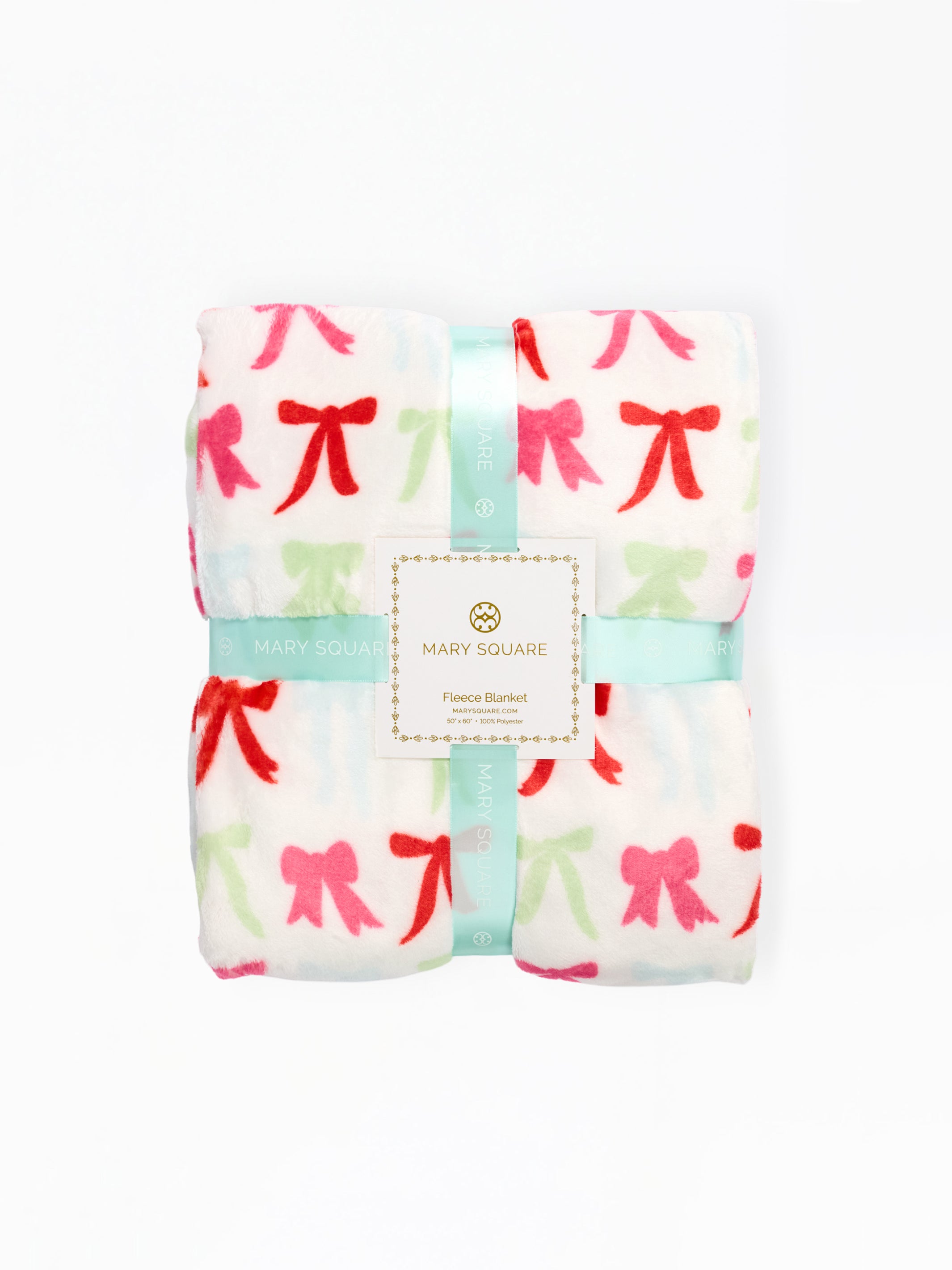 A folded Mary Square fleece blanket with a white background and a repeating bow pattern in red, pink, and light green, wrapped in a mint green ribbon with a central brand label.
