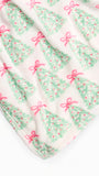 A close-up of a soft white fabric with a repeating Christmas tree print in mint green and pink bows.