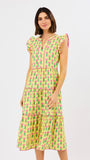 Woman wearing a yellow dress with pink floral pattern on a white background