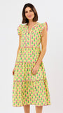Woman wearing a yellow dress with pink floral pattern on a white background