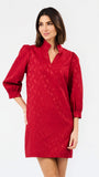 A woman modeling a red textured mini dress with three-quarter puff sleeves and a split neckline, photographed against a plain white studio background.