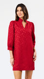 A woman modeling a red textured dress with three-quarter puffed sleeves and a split neckline, photographed against a plain white studio background.