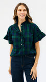 A woman modeling a short-sleeve plaid blouse with ruffle trim and button-front detail, paired with dark blue jeans, against a plain white studio background.
