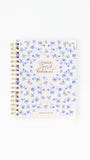 Notebook with floral design and text on a white background