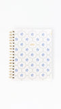 Notebook with floral pattern on white background
