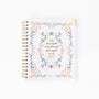 Notebook with floral design and text on a white background