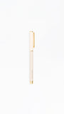 White pen with gold accents on a white background