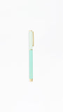 Mint green pen with gold accents on a white background