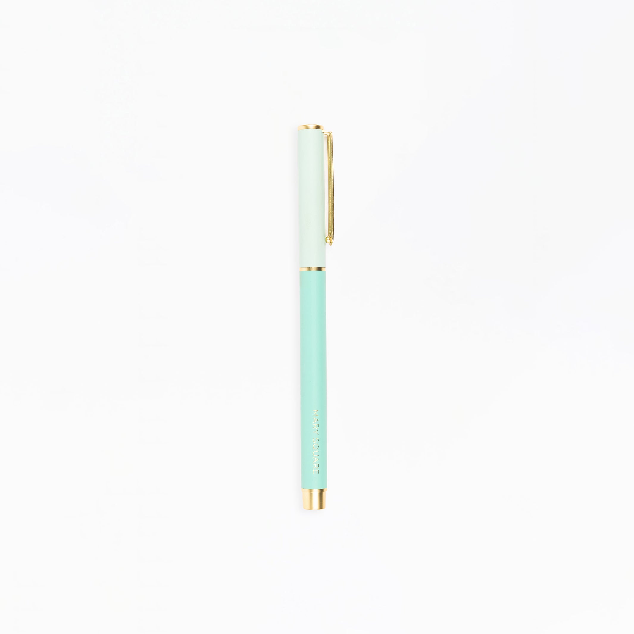 Mint green pen with gold accents on a white background