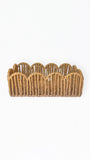 A small woven basket with a scalloped rim, made from natural tan jute or rope, photographed against a plain white background.