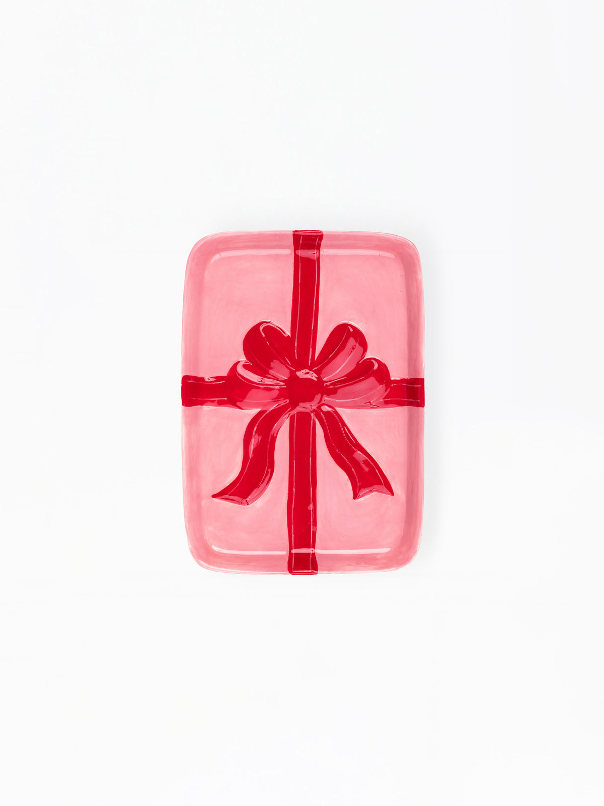 A pink rectangular gift box with rounded corners, wrapped in a glossy red ribbon and bow, centered on a plain white background.