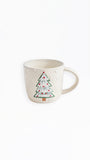 An off-white ceramic mug featuring a hand-painted Christmas tree with green branches, white ornaments, and red lights, set against a plain white background.