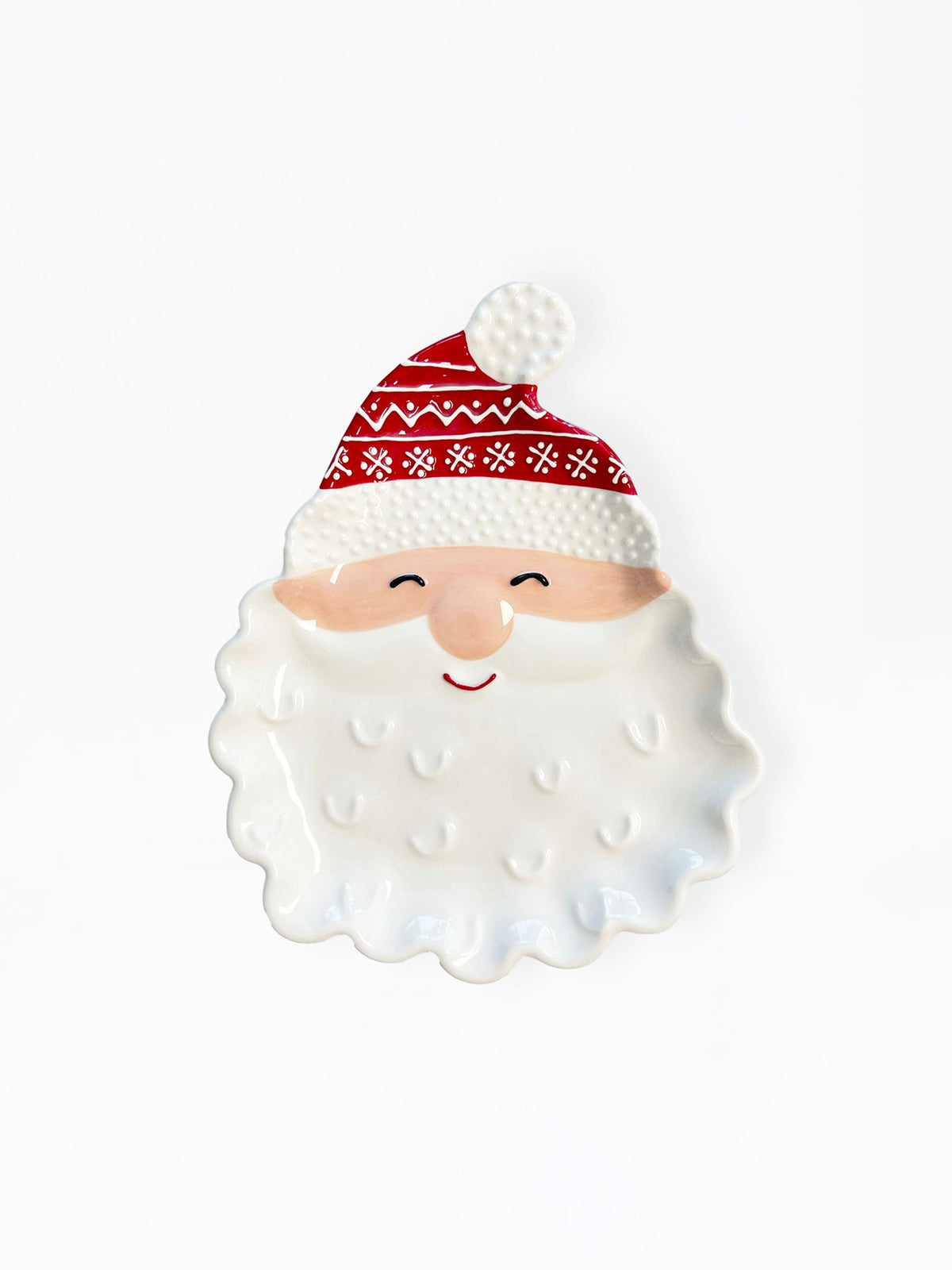 A ceramic Santa Claus face dish with a white textured beard, a beige face, a red patterned hat, and a white pom-pom, photographed on a clean white background.