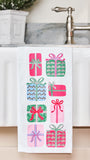 Sequin tea towel with presents on it hanging over the edge of a sink