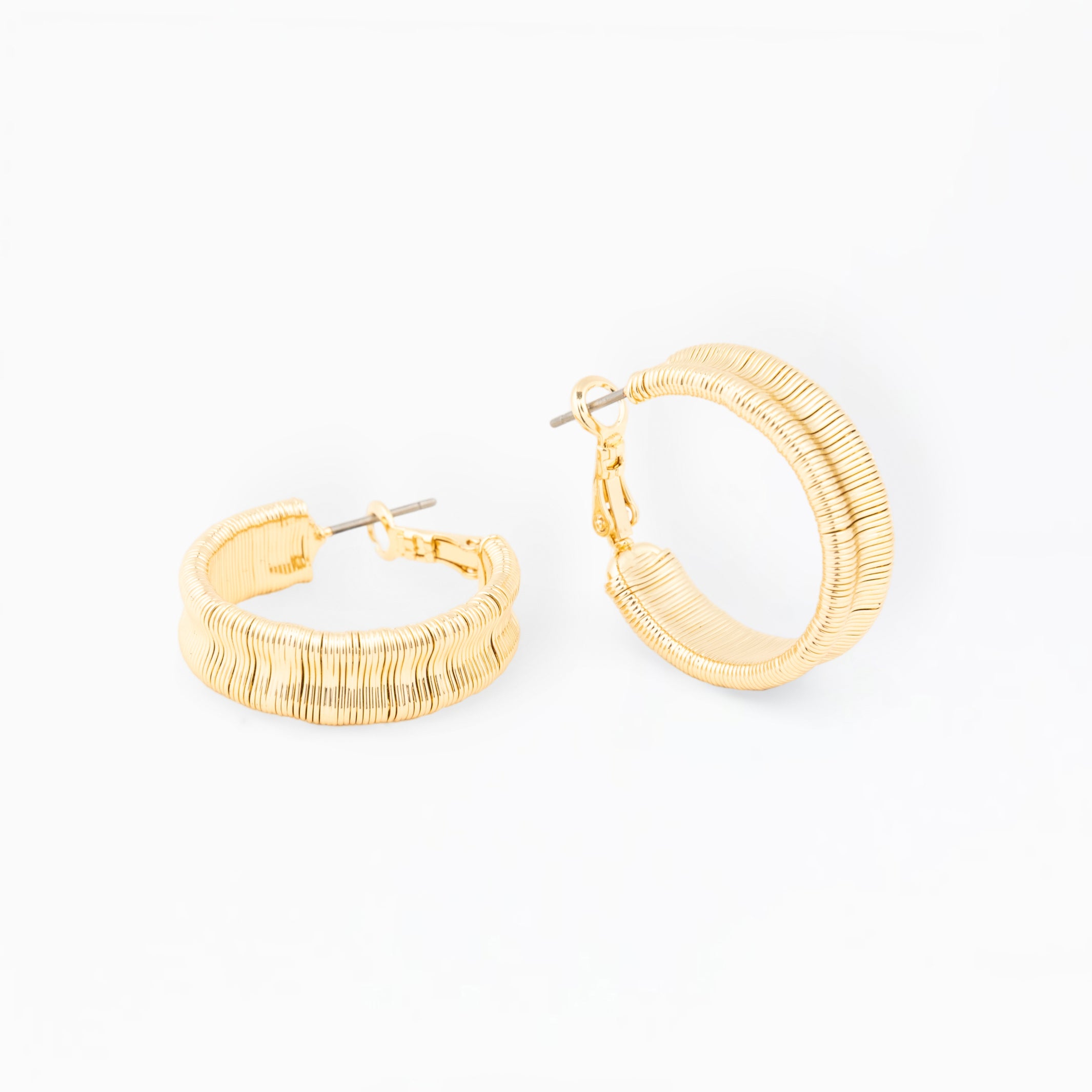 Gold hoop earrings on a white background