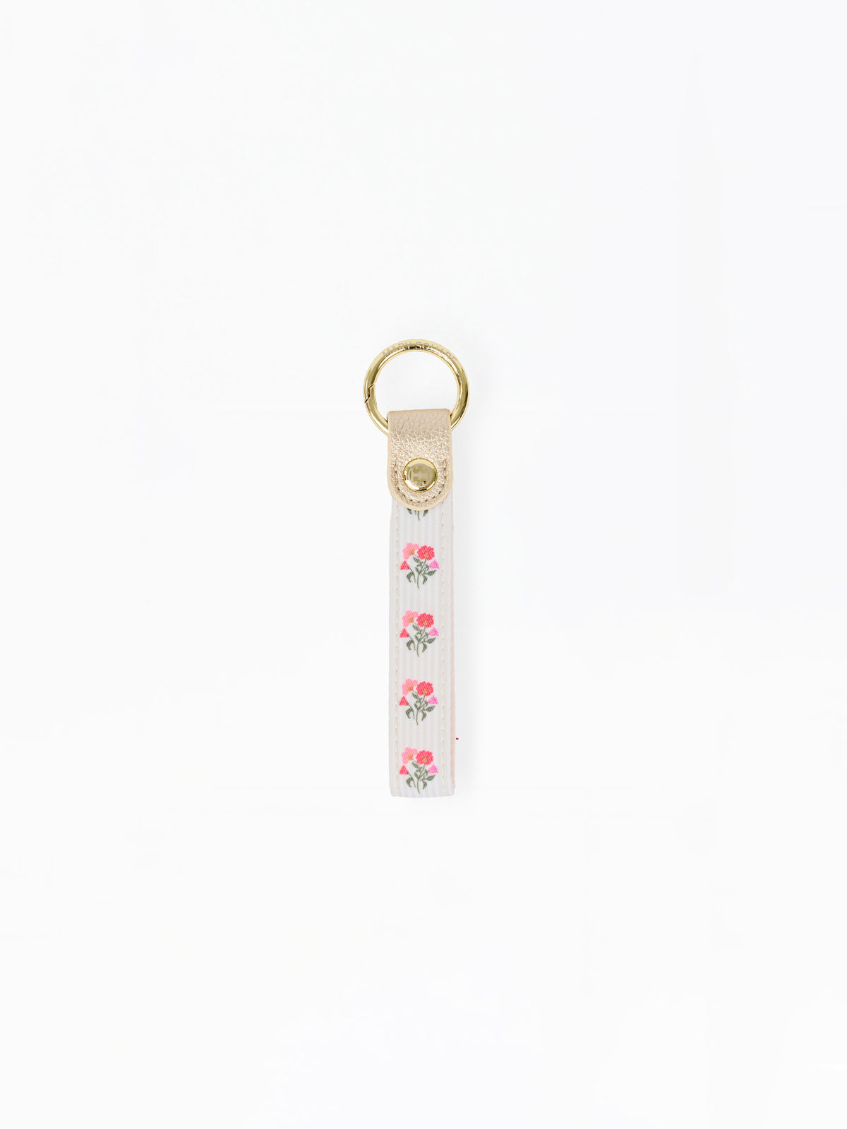 A white fabric keychain strap featuring a vertical pattern of pink roses with green leaves, finished with a beige leather tab and a gold-tone metal key ring at the top.
