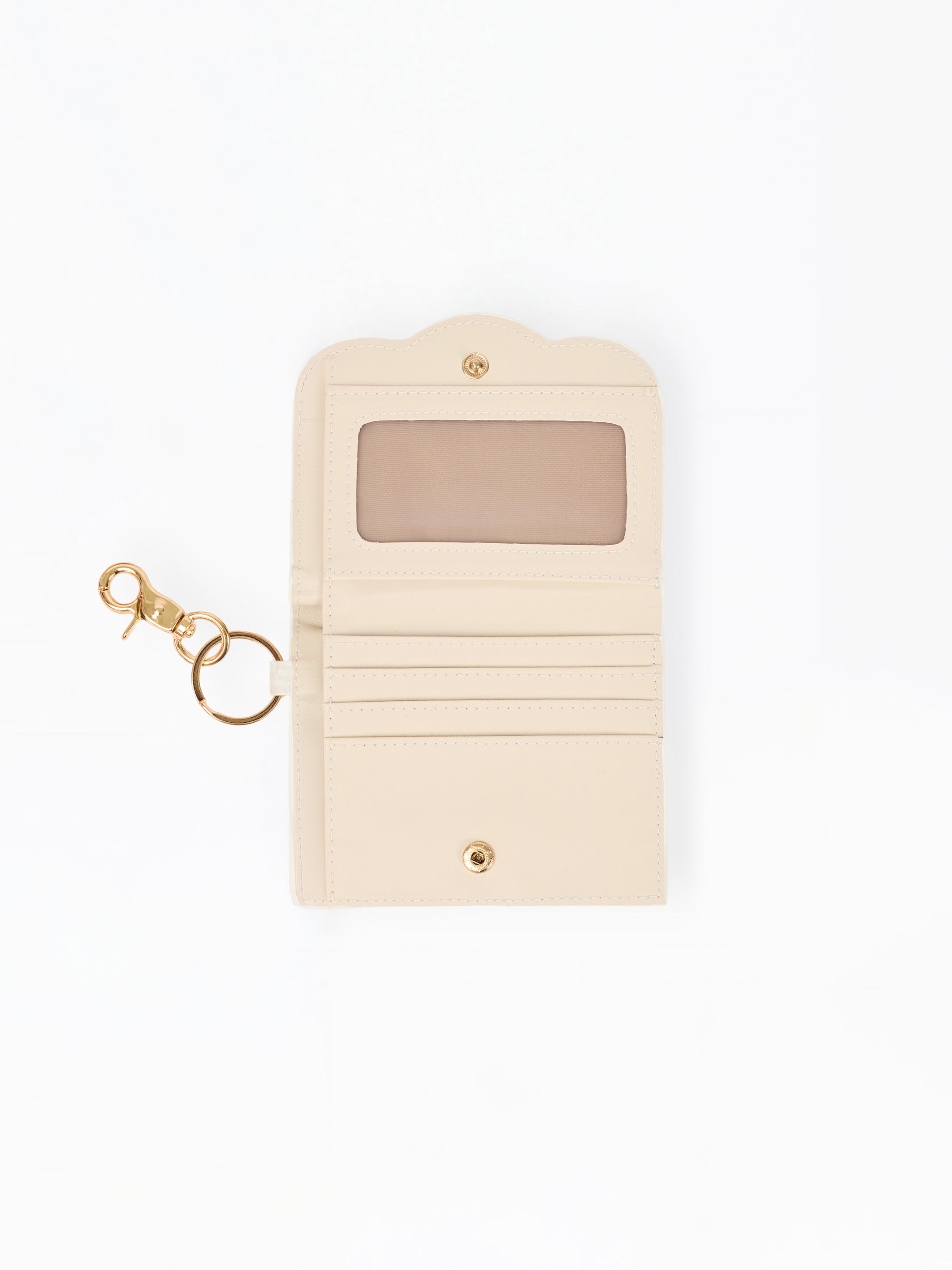 A cream-colored leather key pouch with a gold-tone keyring and clasp, featuring a clear ID window on the front.