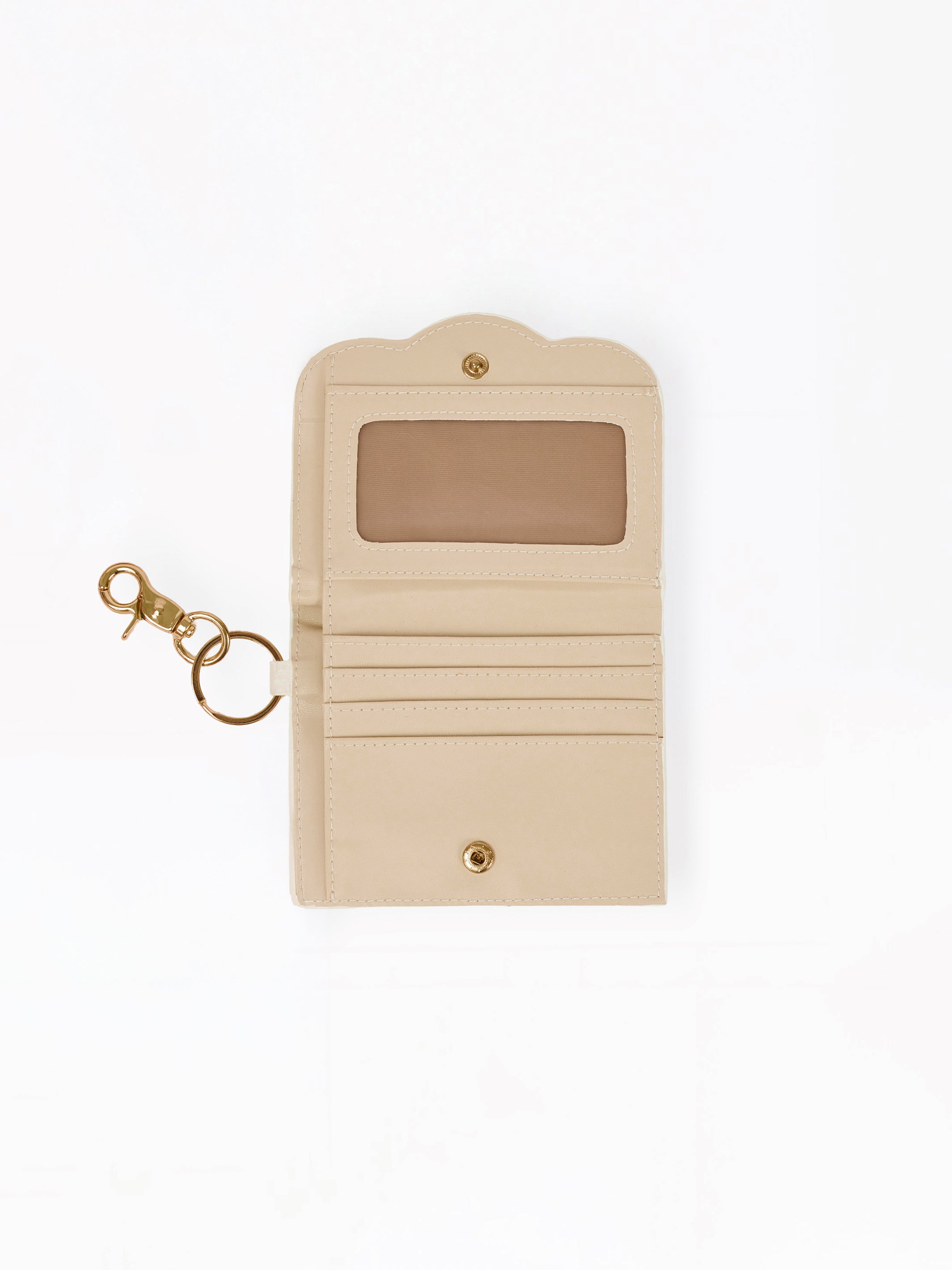 A beige leather card holder wallet with a gold-tone key ring and clasp, featuring a clear ID window on the front, shown on a plain white background.