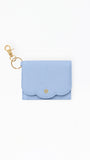 A light blue textured leather key pouch with a scalloped edge and a gold-tone keyring clasp, shown on a plain white background.