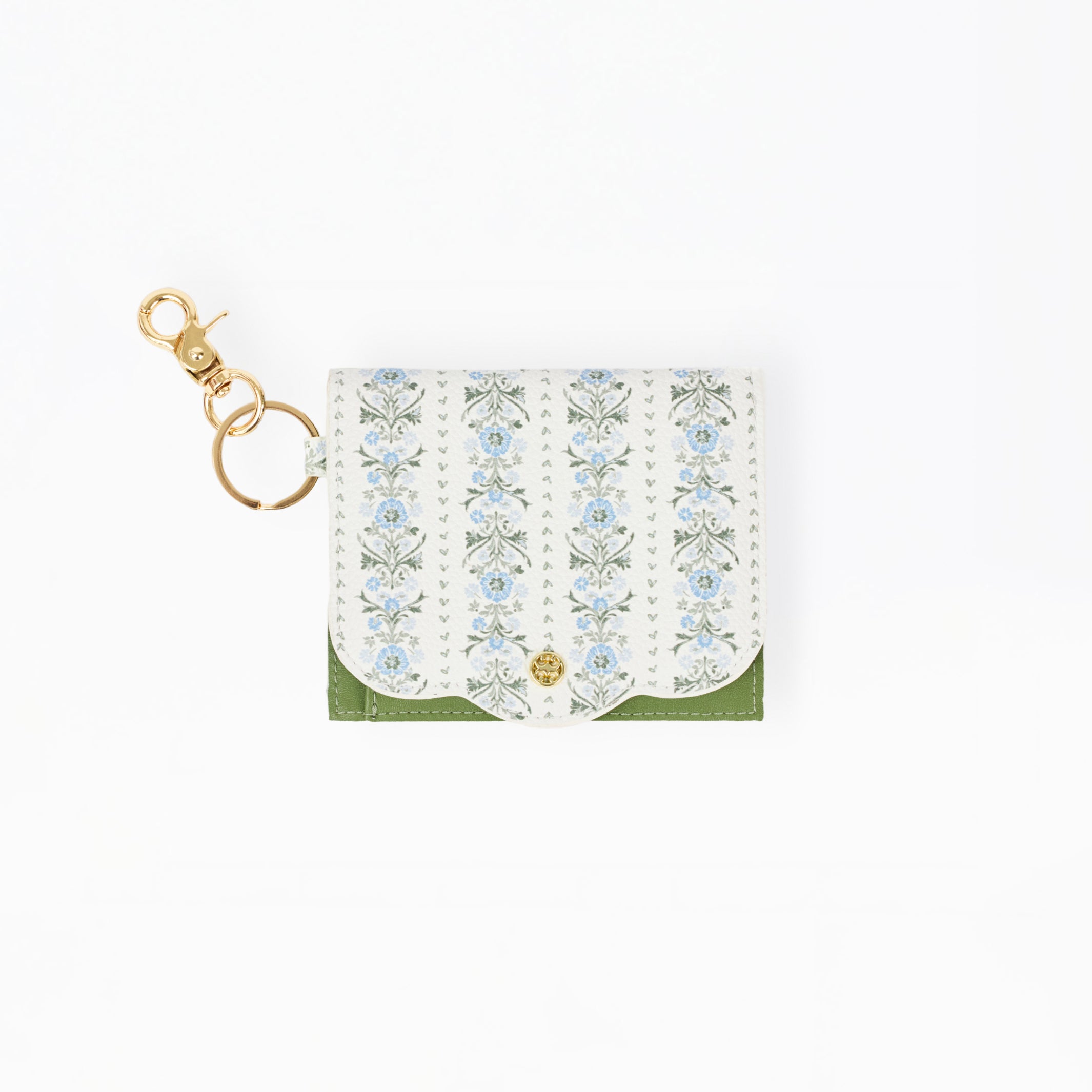 A small white leather card holder or wallet with a delicate blue and green floral pattern, a green bottom border, and a gold-tone key ring clasp on a plain white background.