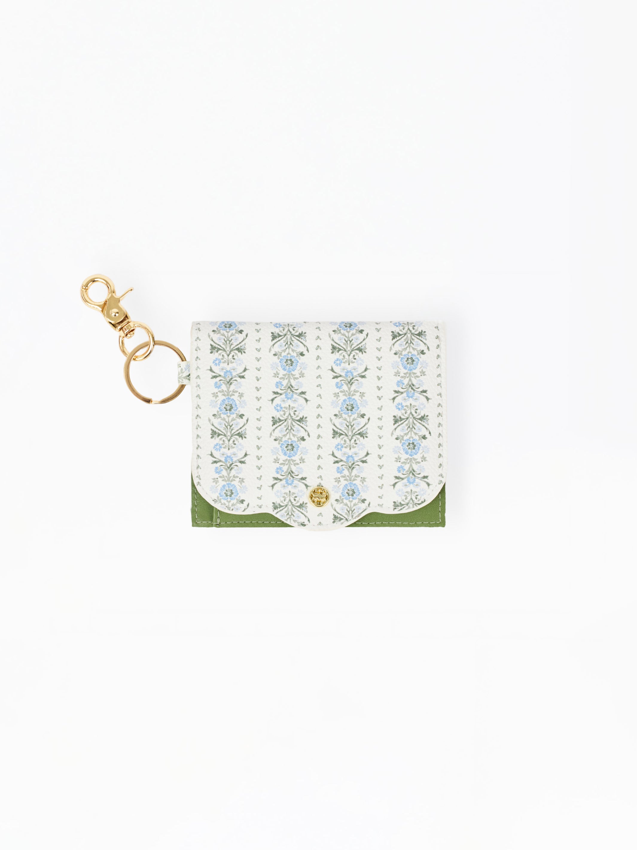 A small white leather card holder or wallet with a delicate blue and green floral pattern, a green bottom border, and a gold-tone key ring clasp on a plain white background.