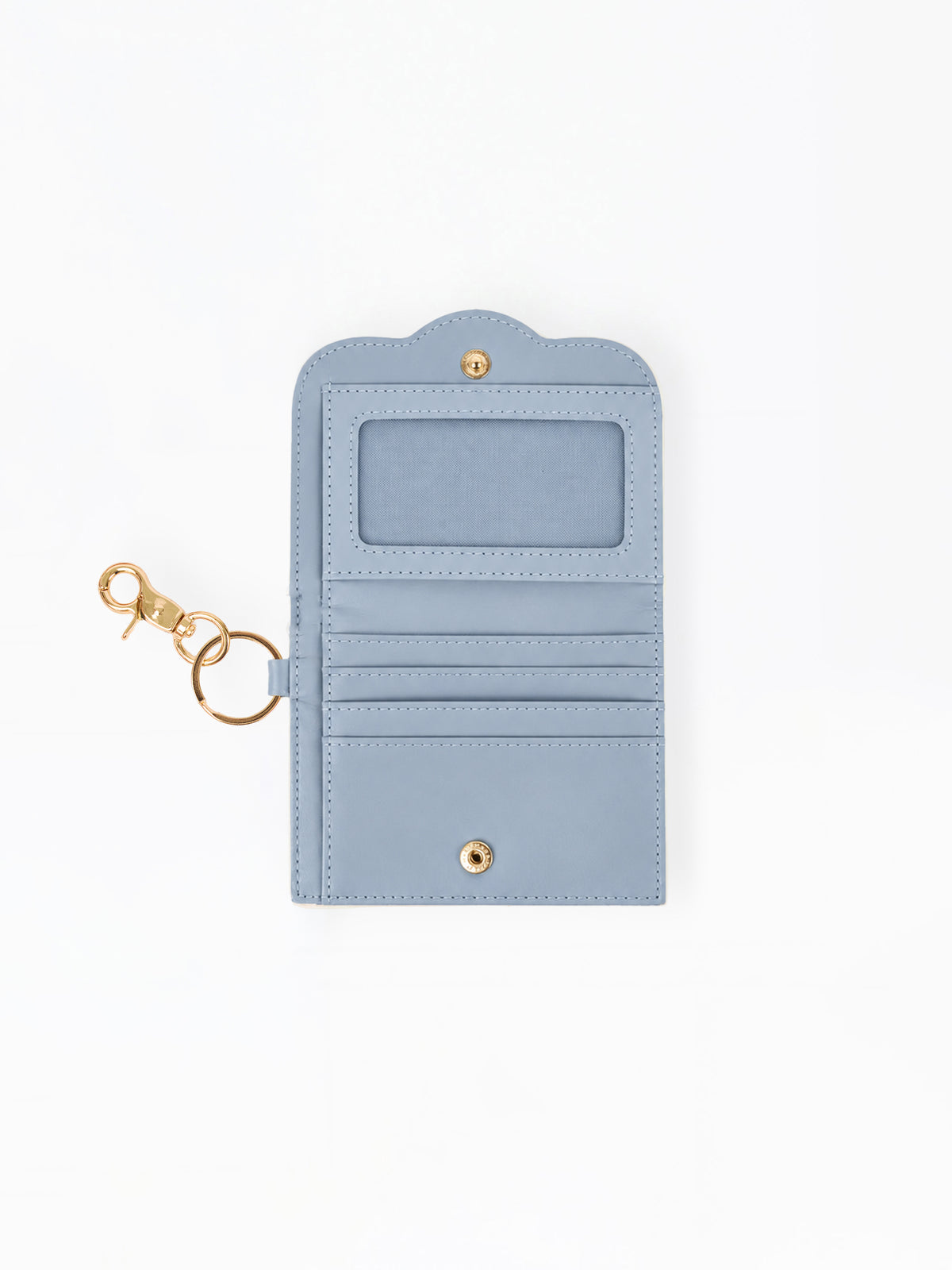 A light blue faux leather wallet with a gold-tone keychain clasp, featuring an ID window, card slots, and a snap button closure, shown on a plain white background.