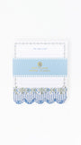 A decorative to-do list notepad by Port & Company, featuring a white top section with 'TO-DO LIST' text, a light blue middle band with gold lettering, and a blue and white striped scalloped bottom edge with floral washi tape accents.