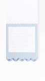 A white lined notepad with a blue and white striped border and a scalloped decorative edge, shown on a plain white background.