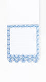 A white lined notepad page with a decorative blue and white damask-patterned border, shown on a clean white background.