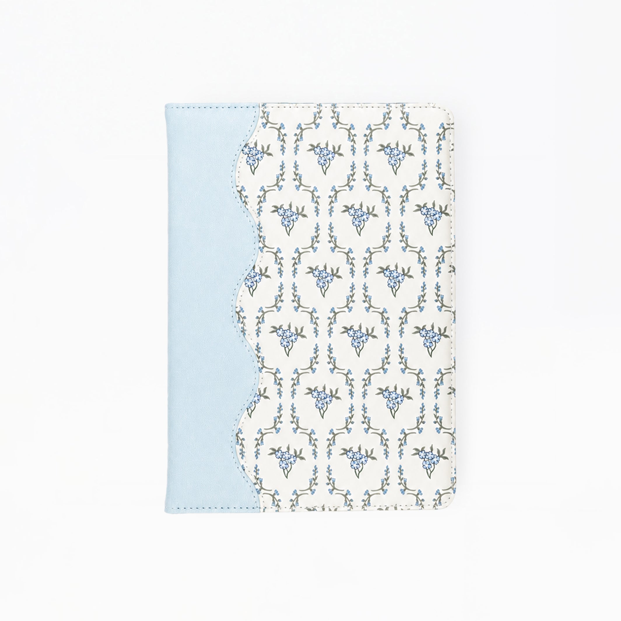 A notebook featuring a light blue side panel and a white front cover with a repeating blue ornamental pattern, shown on a plain white background.