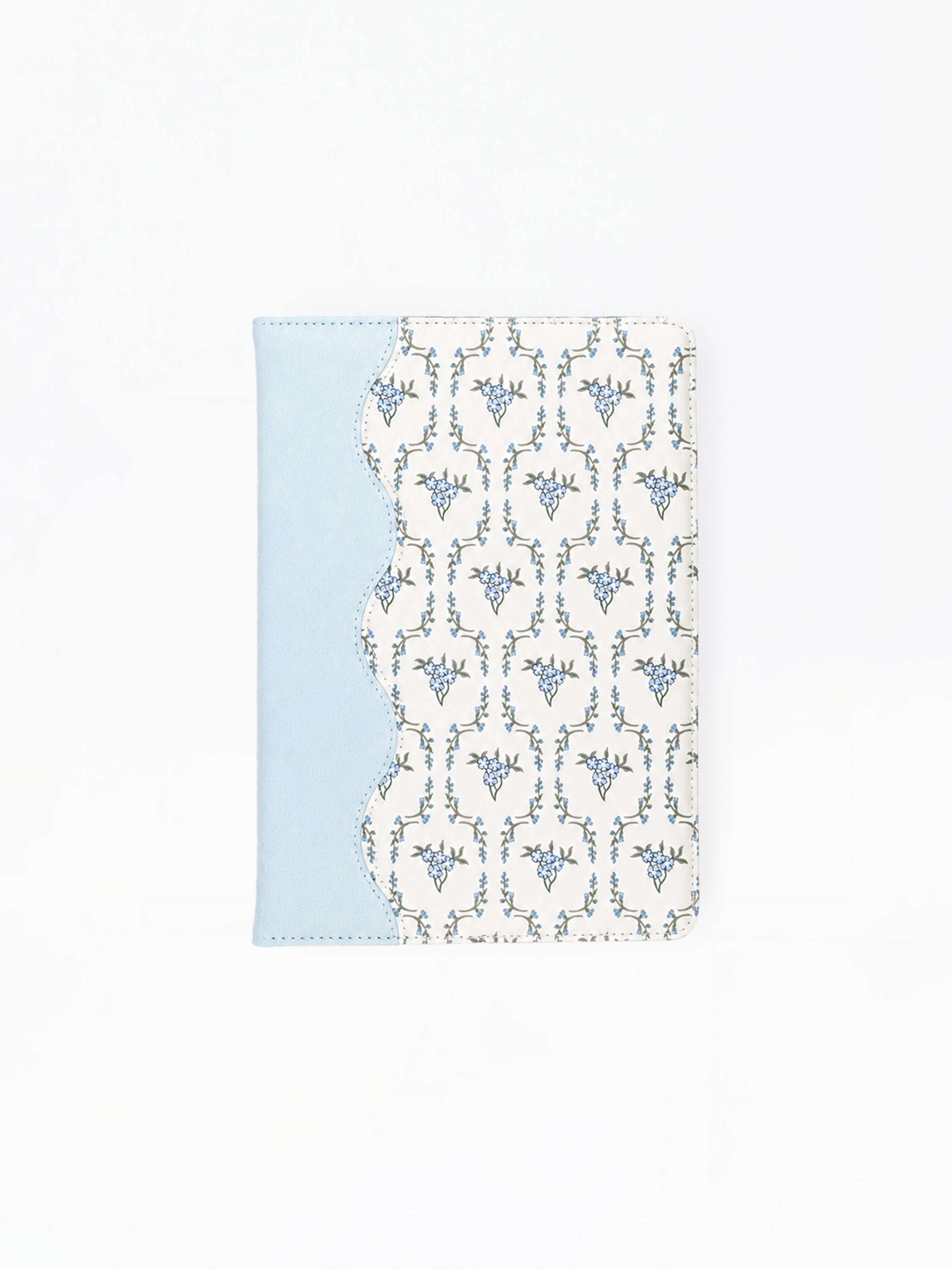 A notebook featuring a light blue side panel and a white front cover with a repeating blue ornamental pattern, shown on a plain white background.