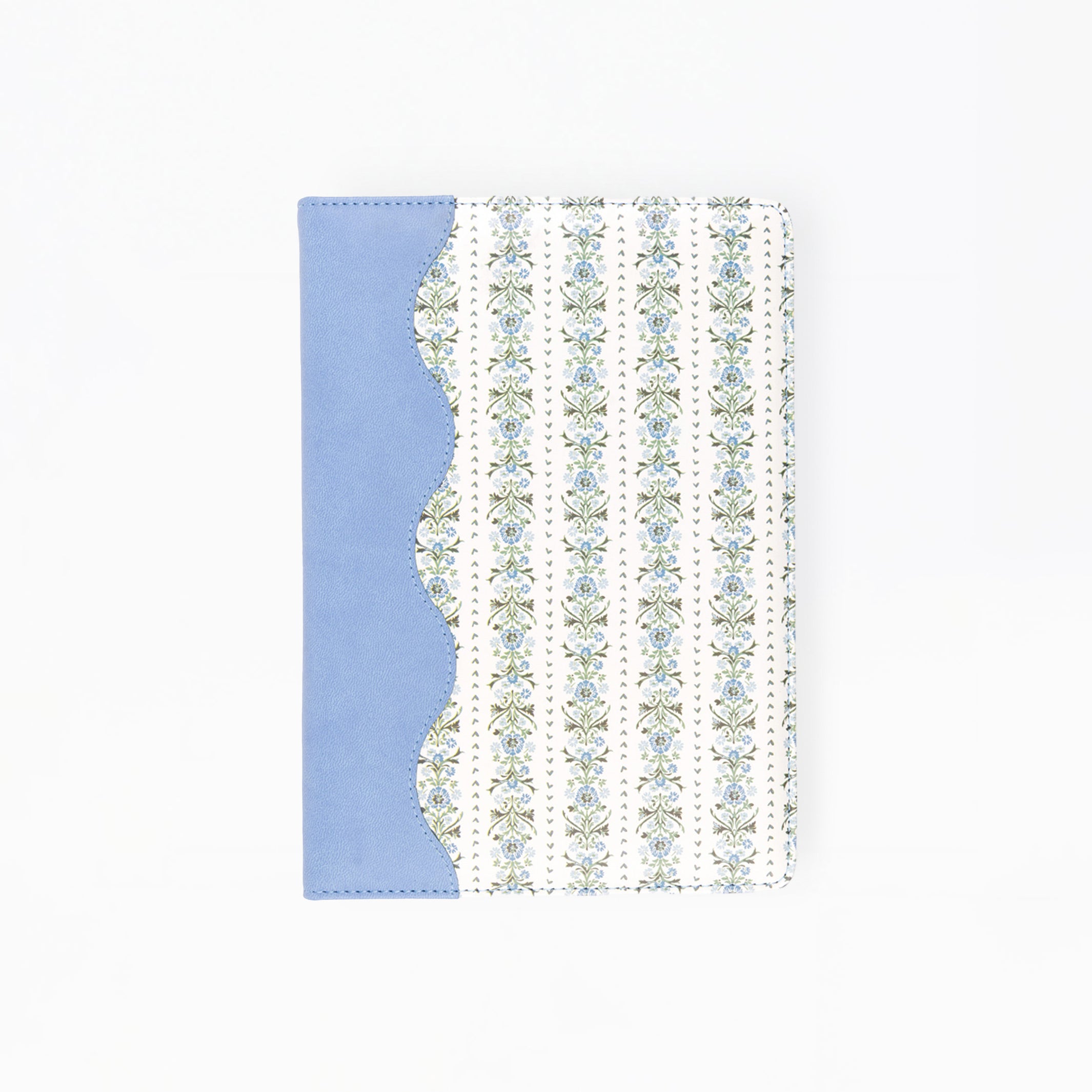 A notebook or journal with a light blue cover on the left and a white cover on the right featuring vertical stripes of small floral motifs, shown on a plain white background.