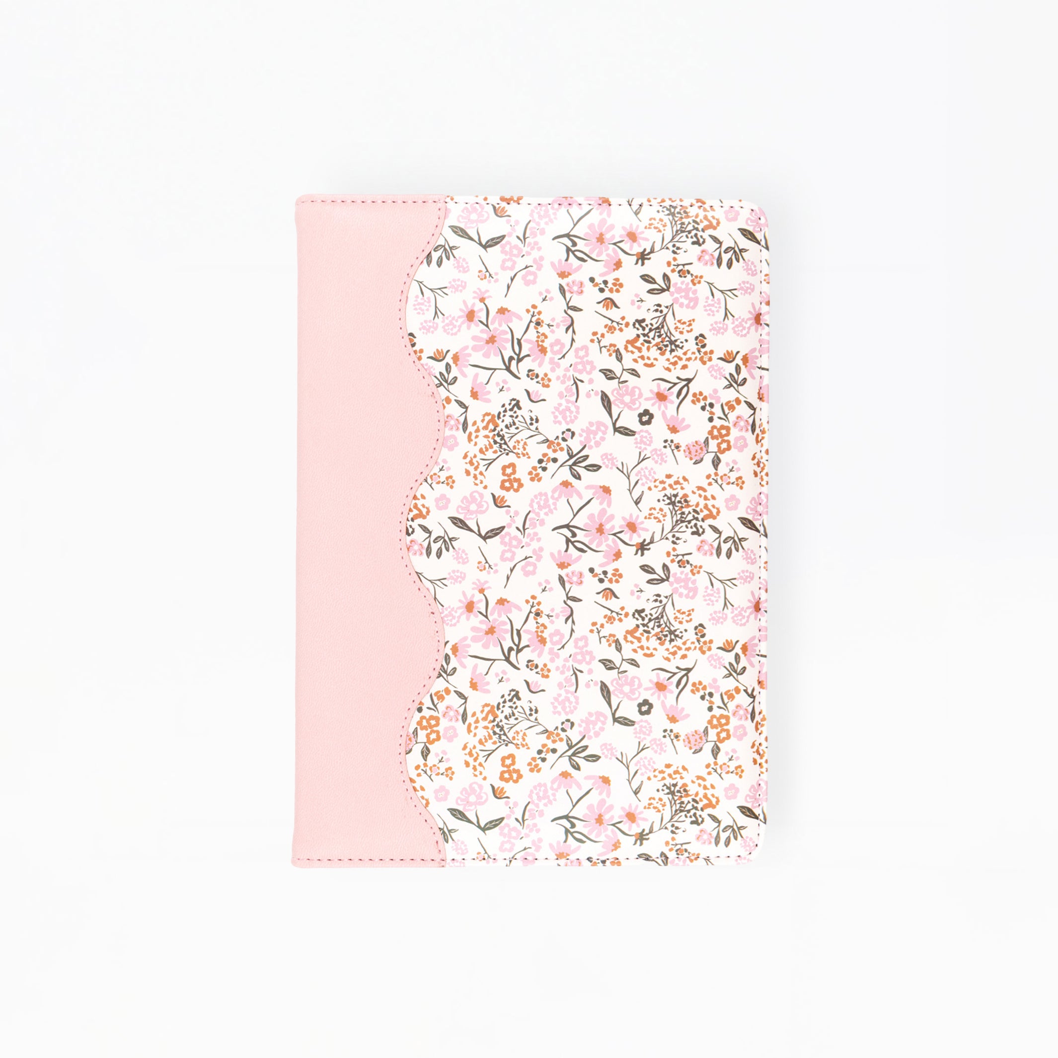 A notebook or journal cover featuring a light pink solid panel on the left and a scalloped edge with a dense pink, white, and green floral pattern on the right, shown against a plain white background.