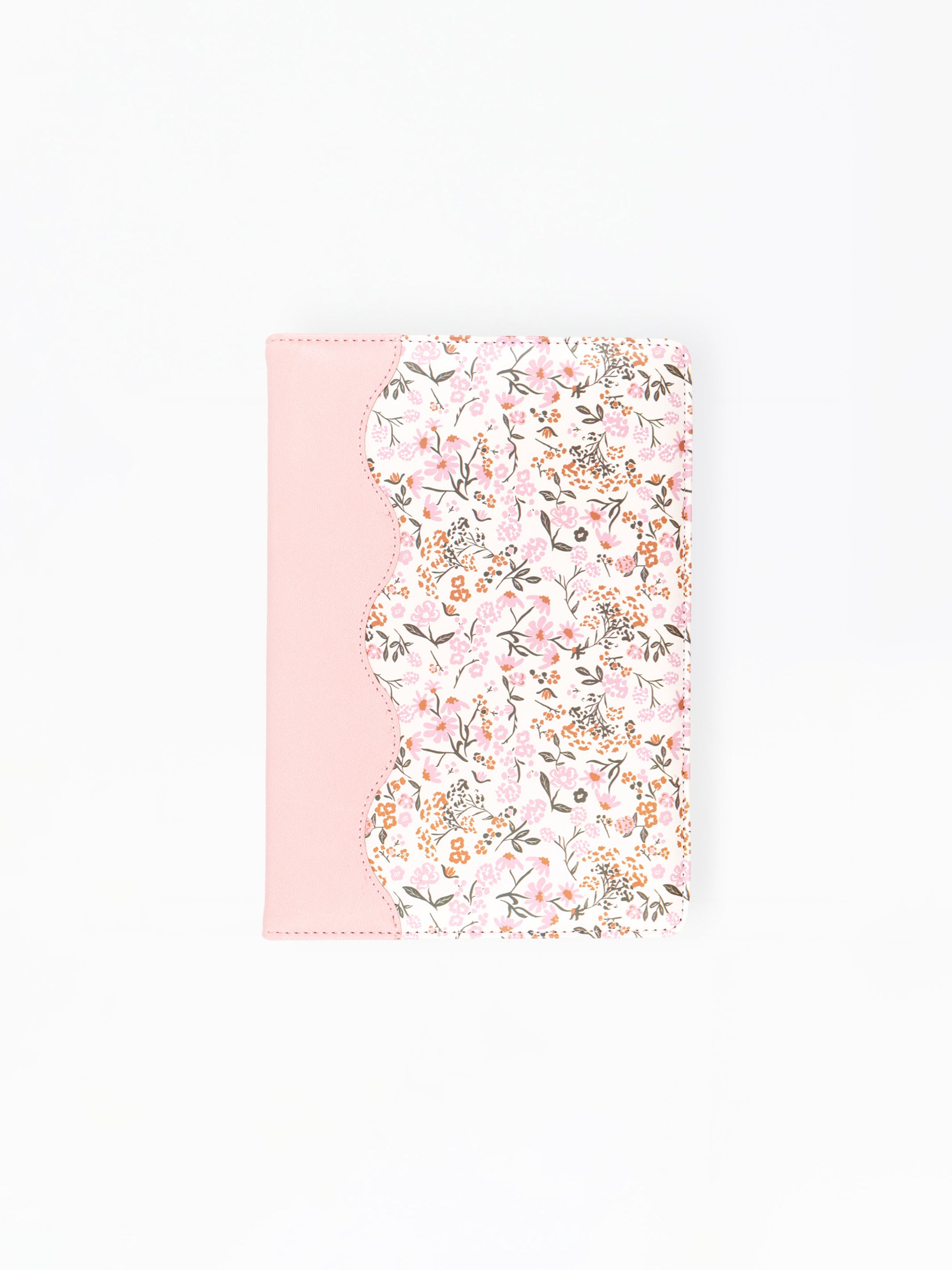 A notebook or journal cover featuring a light pink solid panel on the left and a scalloped edge with a dense pink, white, and green floral pattern on the right, shown against a plain white background.