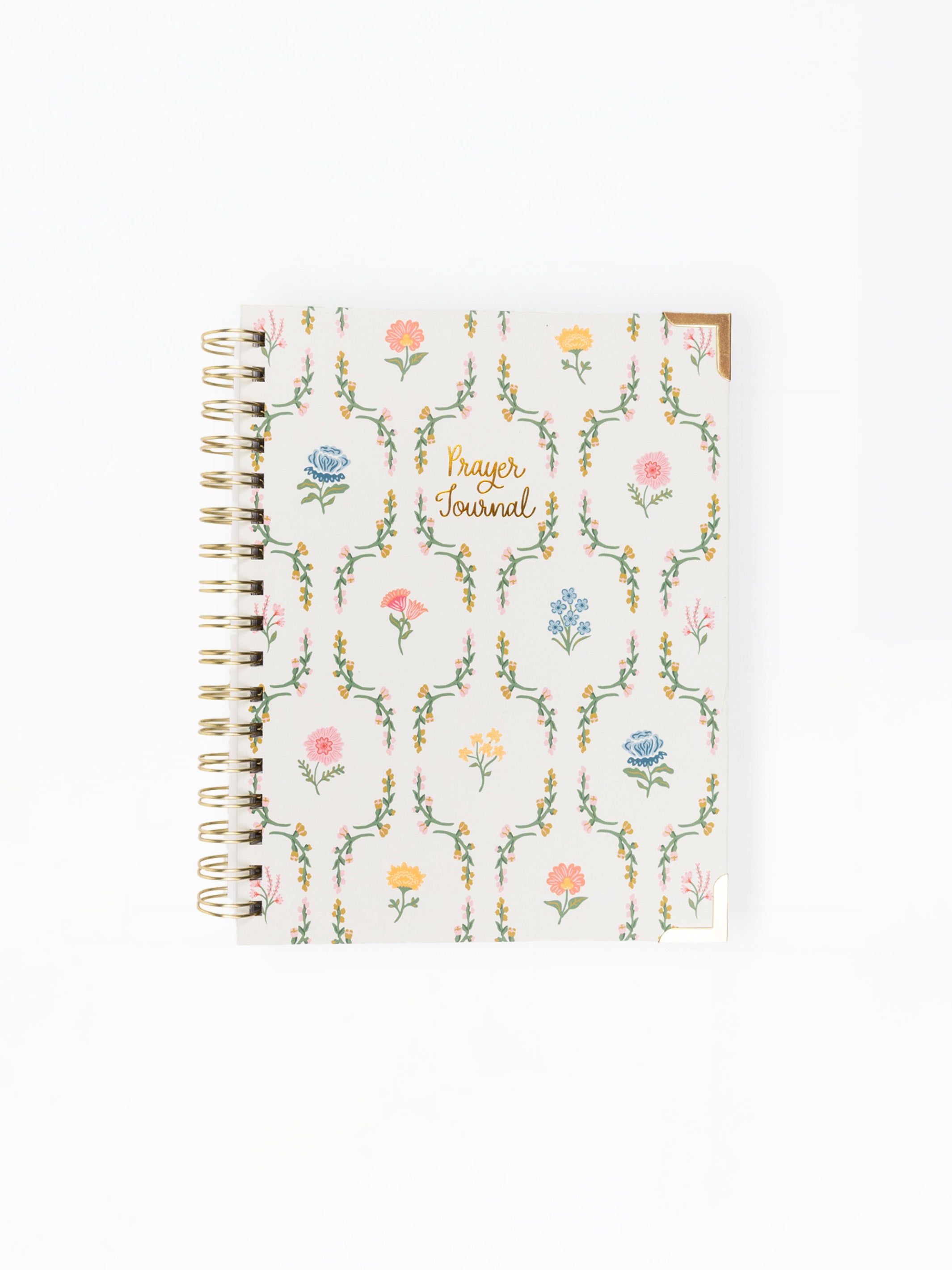 A spiral-bound prayer journal with a cream-colored cover decorated with a delicate multicolor floral and vine pattern, featuring gold foil lettering that reads 'Prayer Journal'.